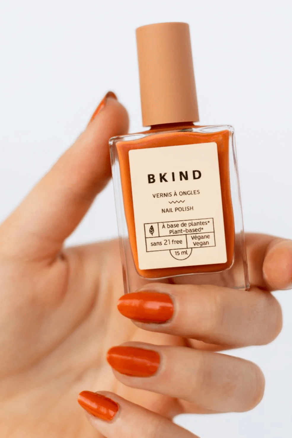 une main tenant un vernis à ongles pour femme enceinte